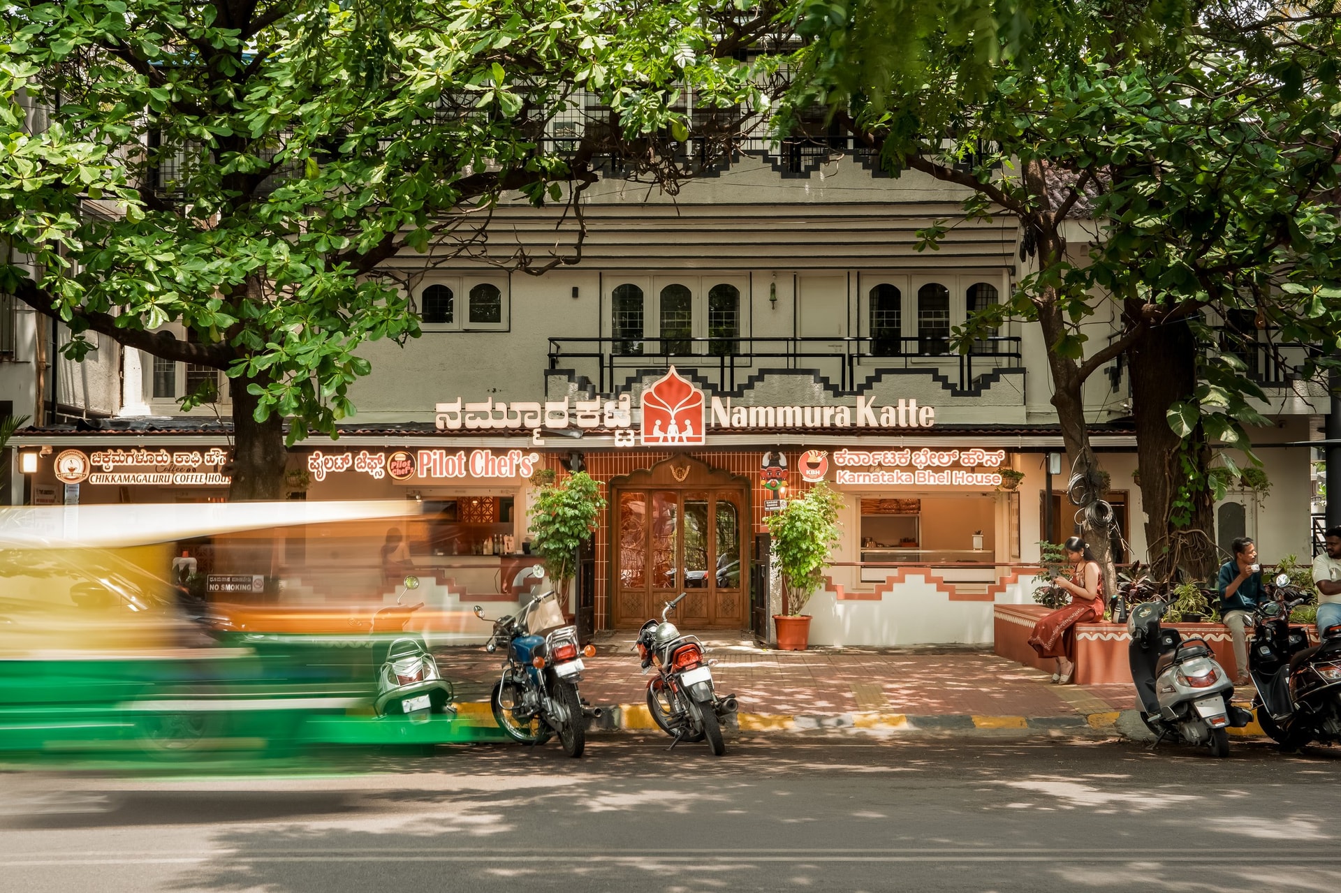 The building seen from across the road, the ground-floor intervention completing the older bungalow above it