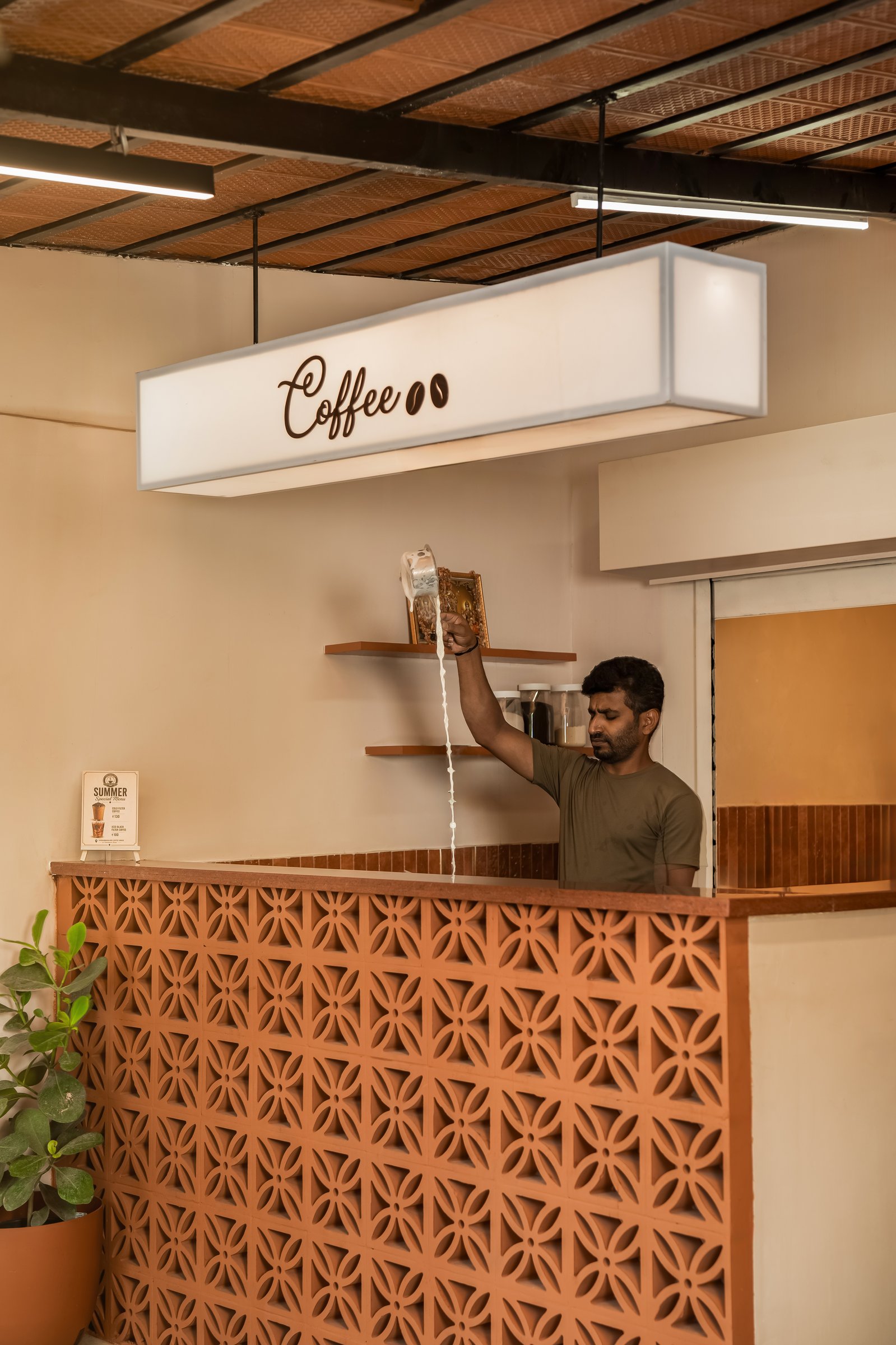 The Chikkamagaluru Coffee House counter, fronted by a perforated terracotta jali