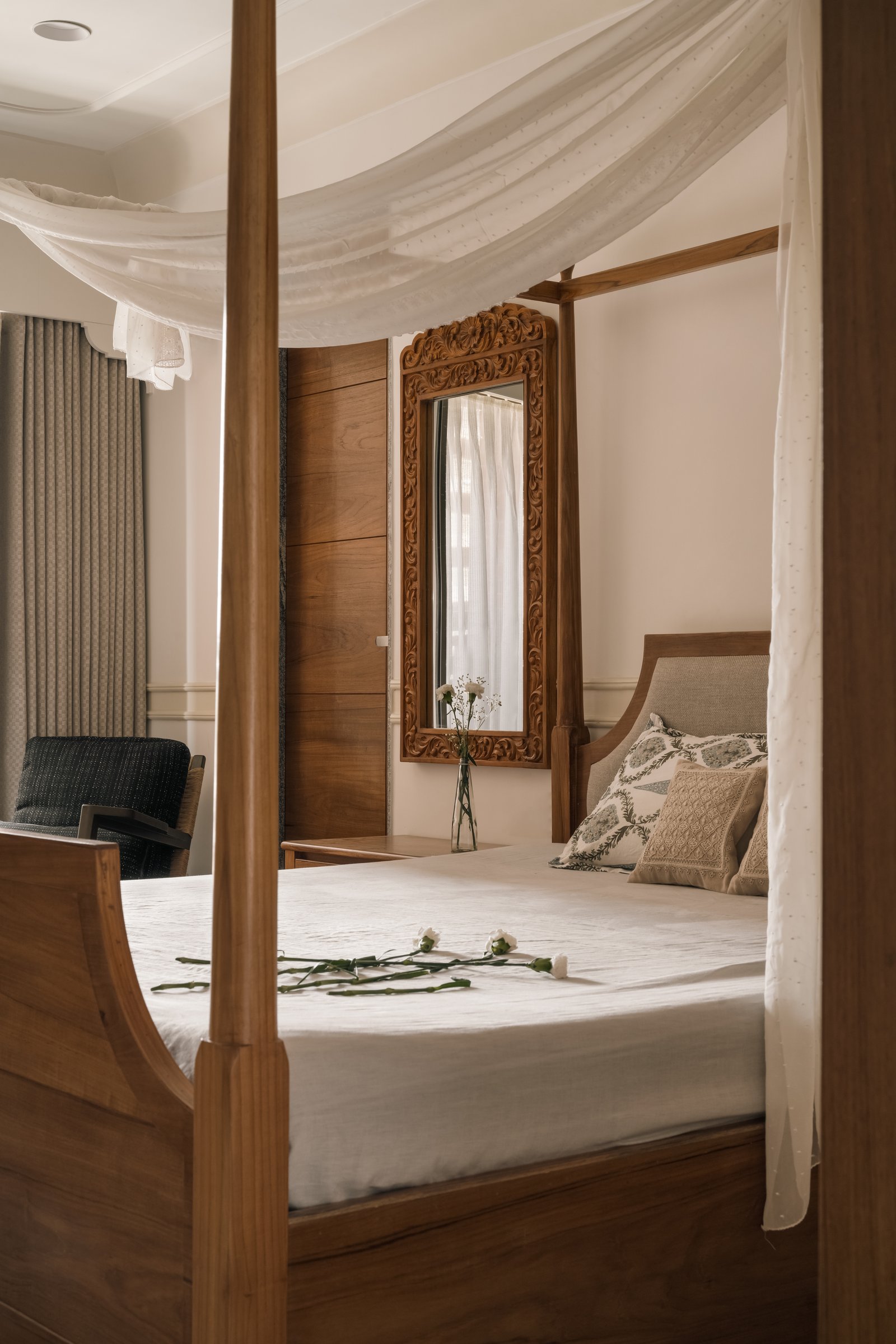 The master bedroom, where a four-poster bed with a curved sleigh footboard anchors the room