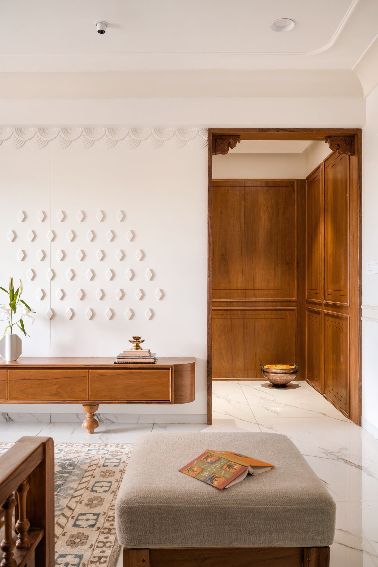 The foyer, where a hexagonal plaster relief and a scalloped border reinterpret traditional welcome motifs