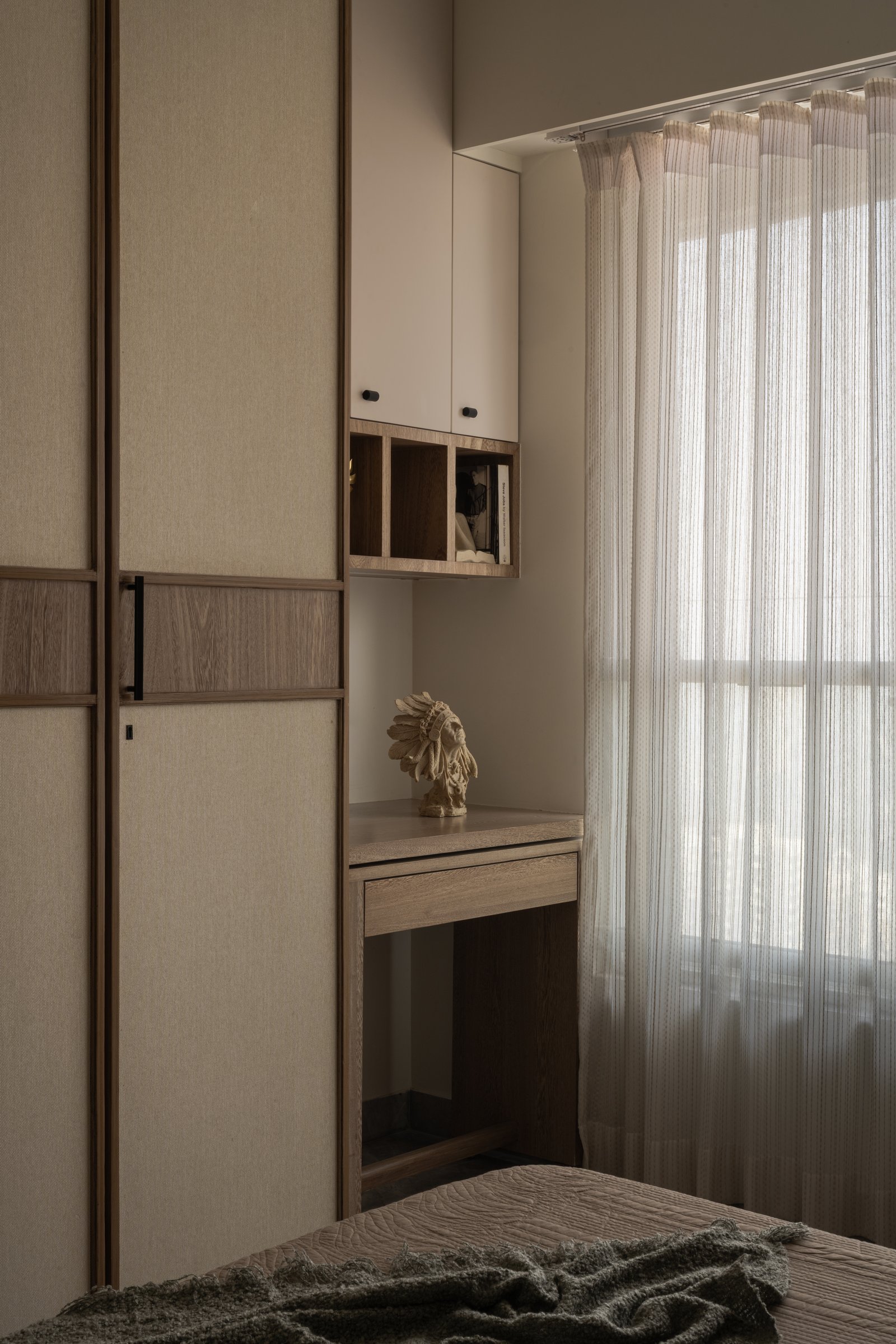 A study nook within the master bedroom carries the room's restraint into a still-life composition