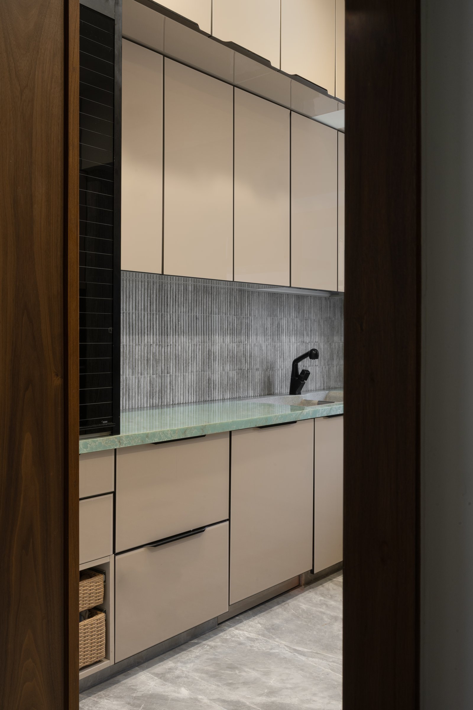 A second view of the working zone shows cabinetry rising cleanly to the ceiling, no flourish, only discipline