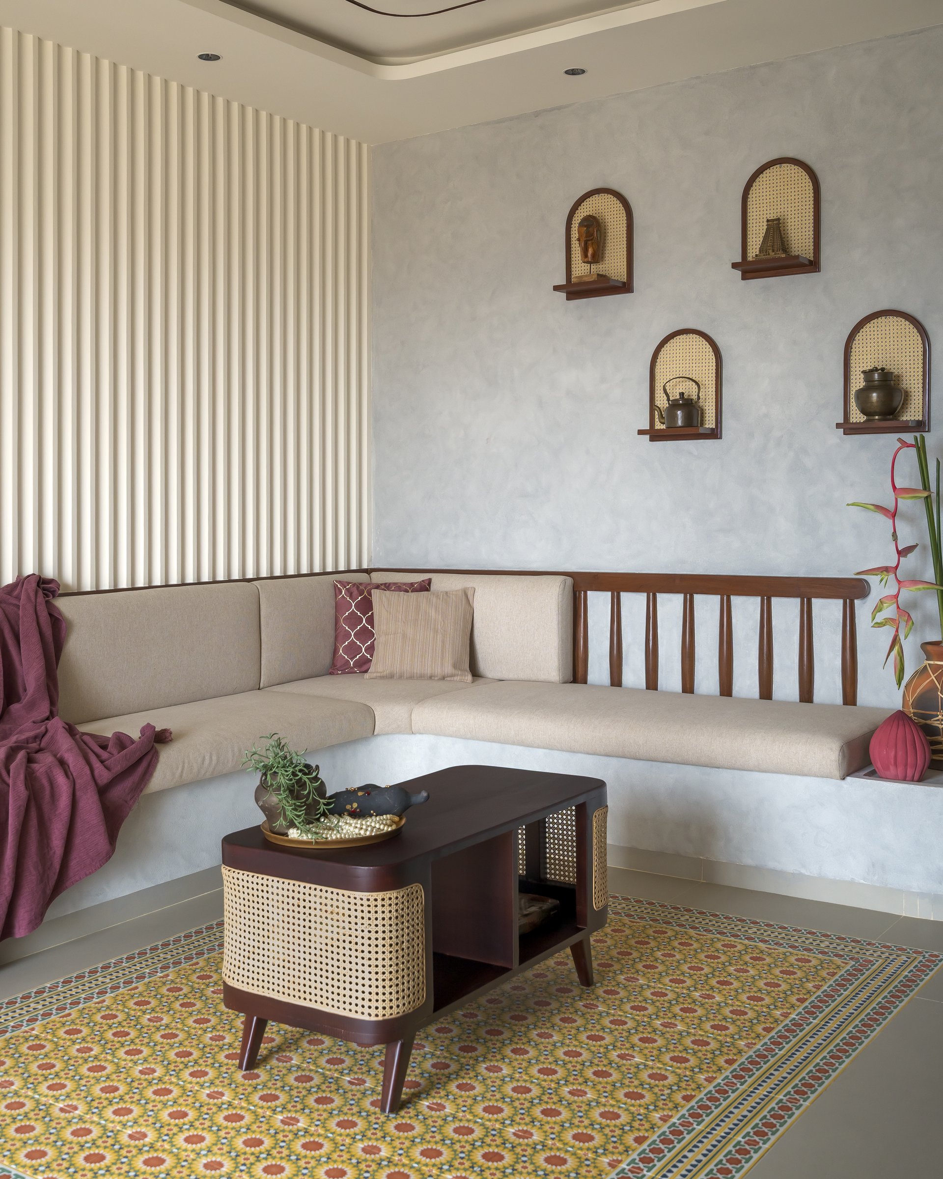The living room's built-in banquette, where arched cane-backed niches punctuate a lime-plastered wall