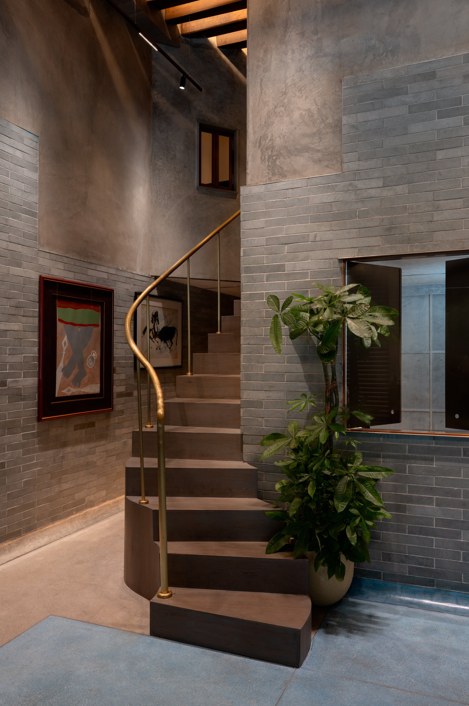 The ascent to the mezzanine, where hand-worked plaster meets fine brick coursework at hand height