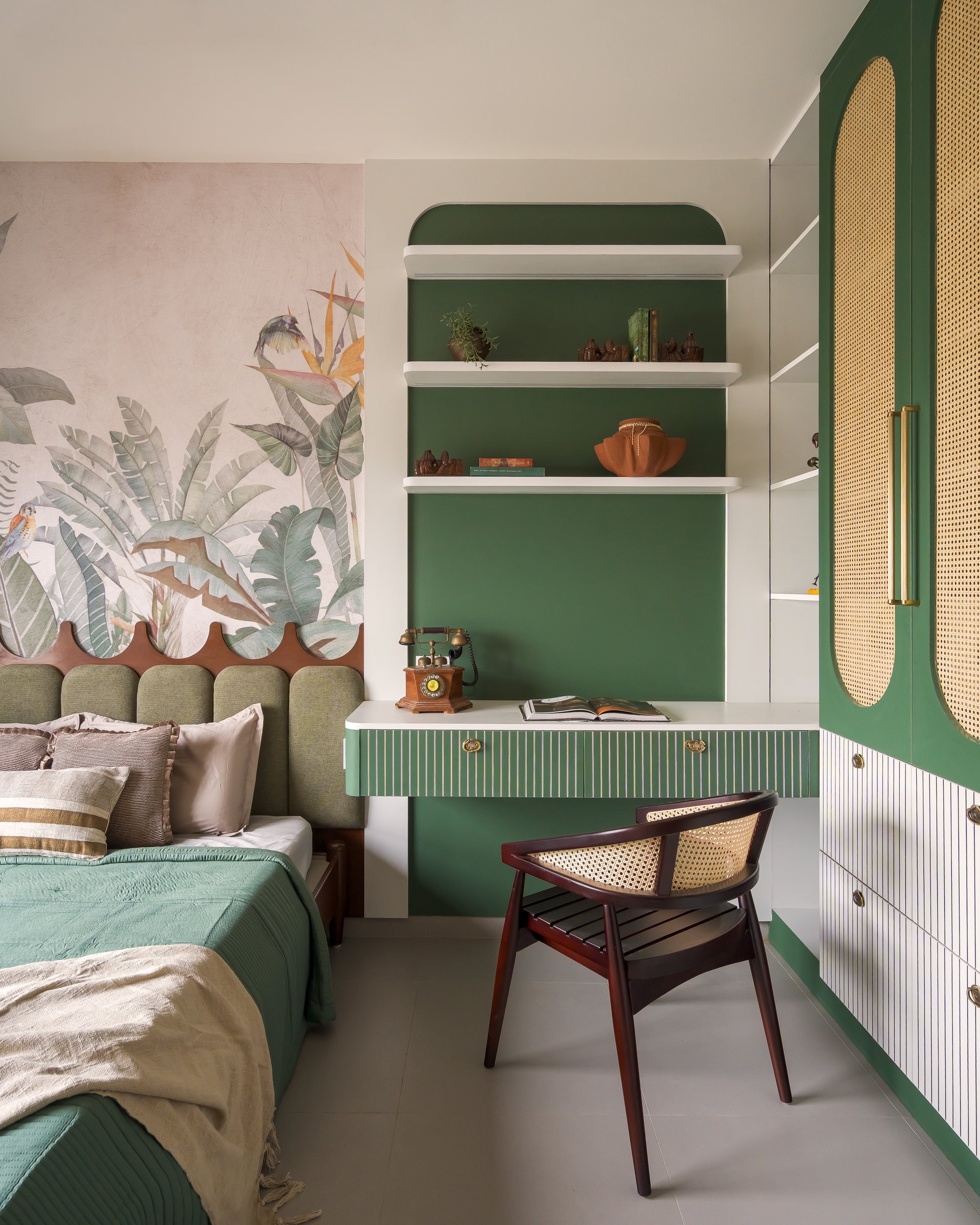 The children's study niche, set into an arched green recess beside cane-panelled wardrobes