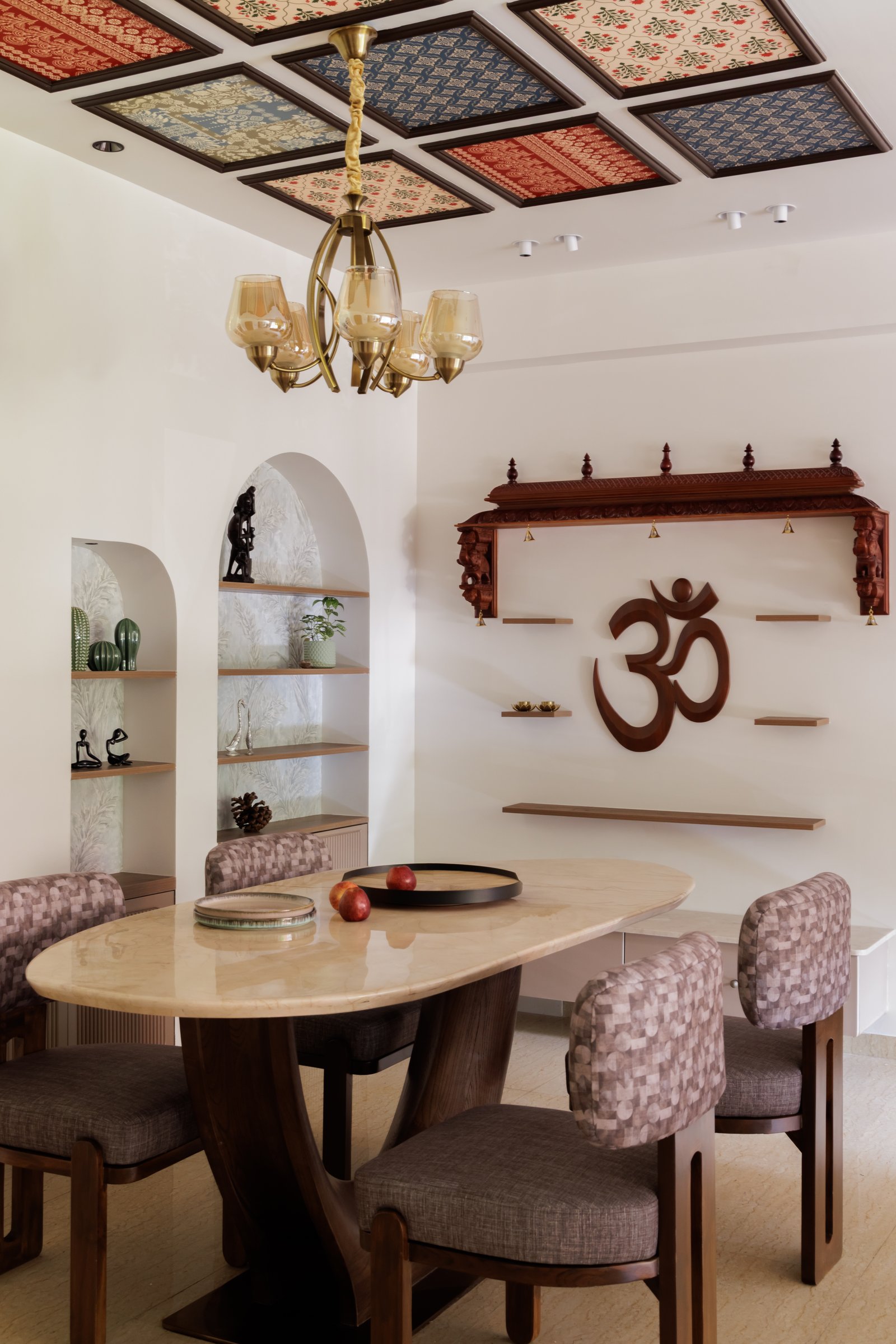 The dining area, where a coffered ceiling of framed textile panels holds the home's boldest cultural gesture overhead