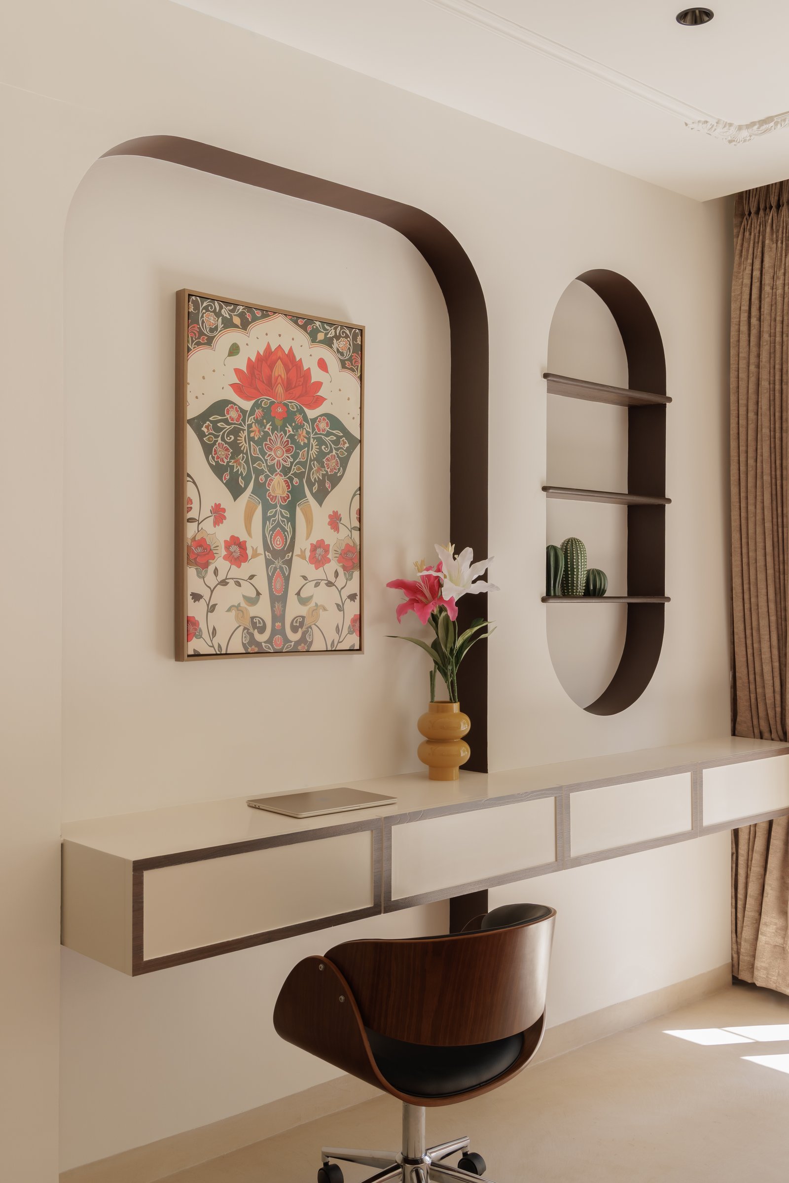The study niche, where a folk-inspired artwork of an elephant and lotus sits within a softly arched wall composition