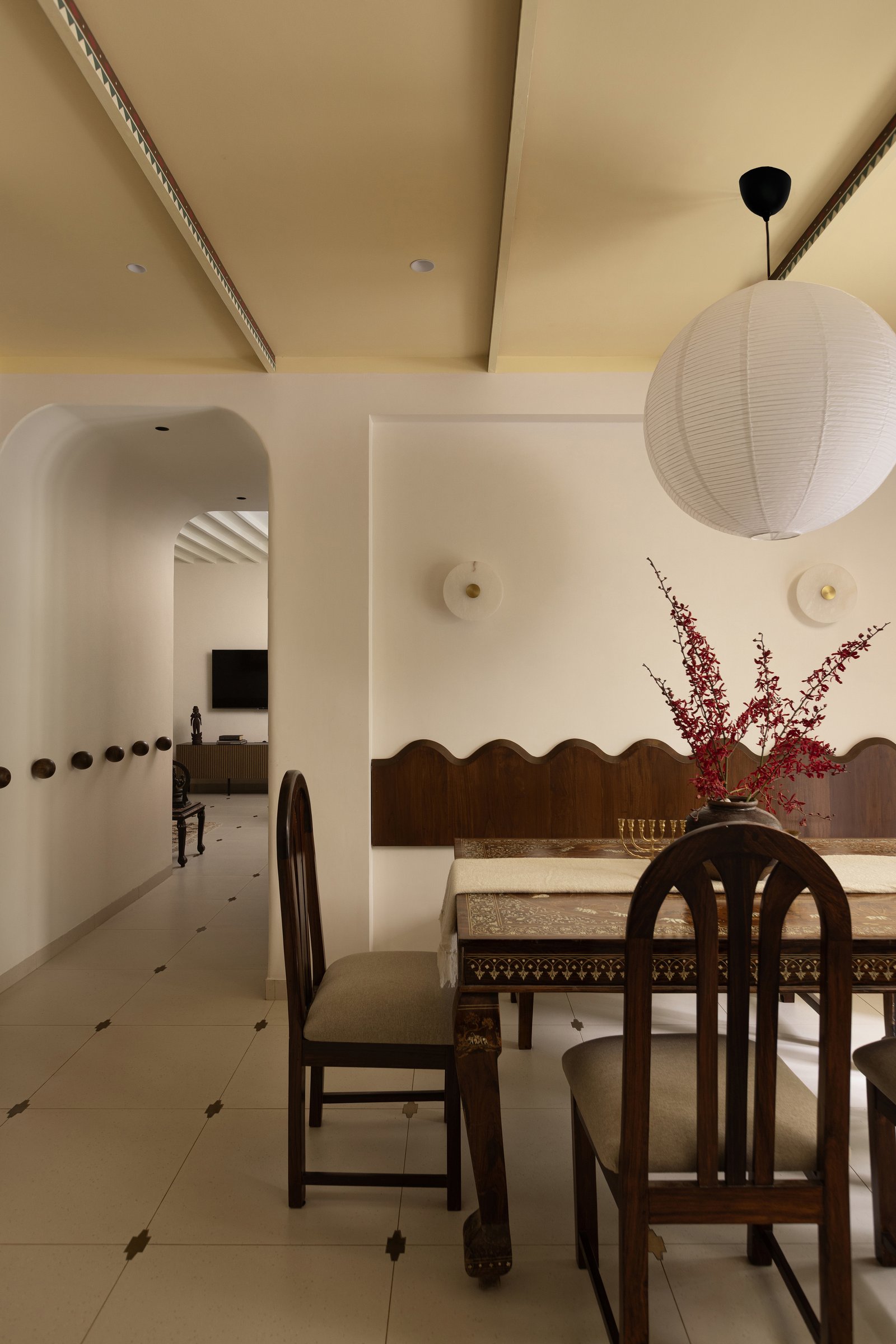 The dining room, anchored by a rosewood table with ivory inlays of elephants and lotus motifs