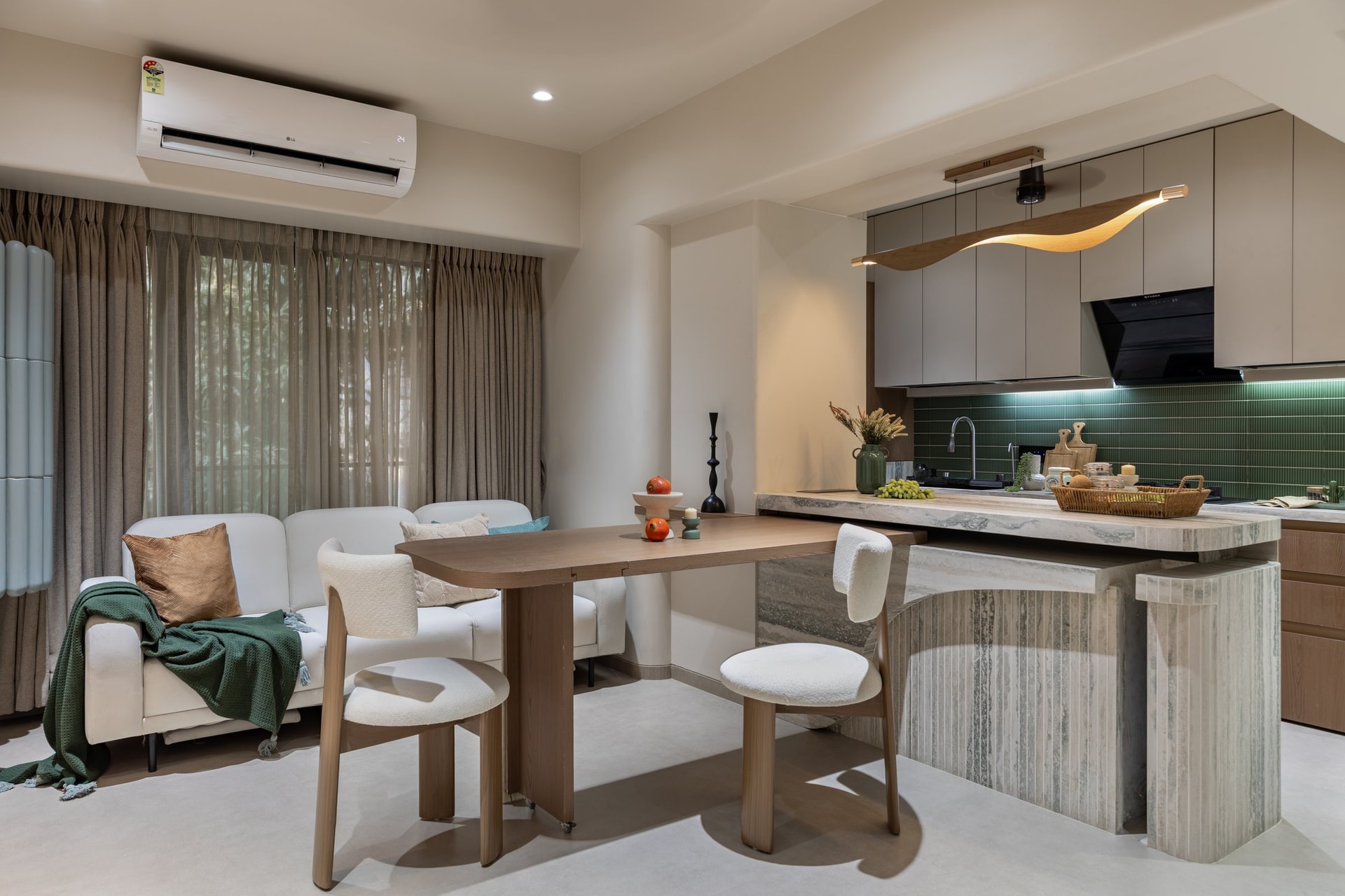 The foldable dining table rotates into the kitchen island, allowing the room to change use through the day
