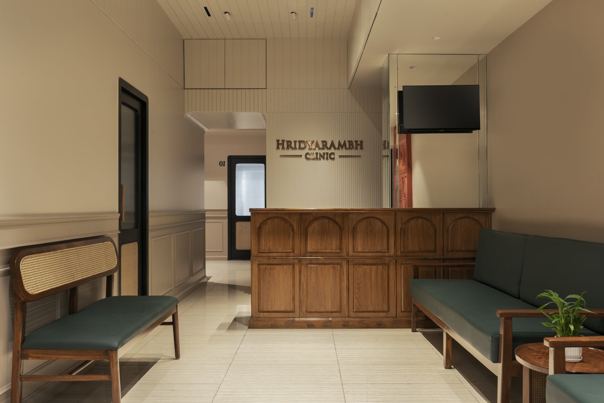 The reception, where an arched-panel wooden counter and cane-backed benches establish the clinic's material grammar
