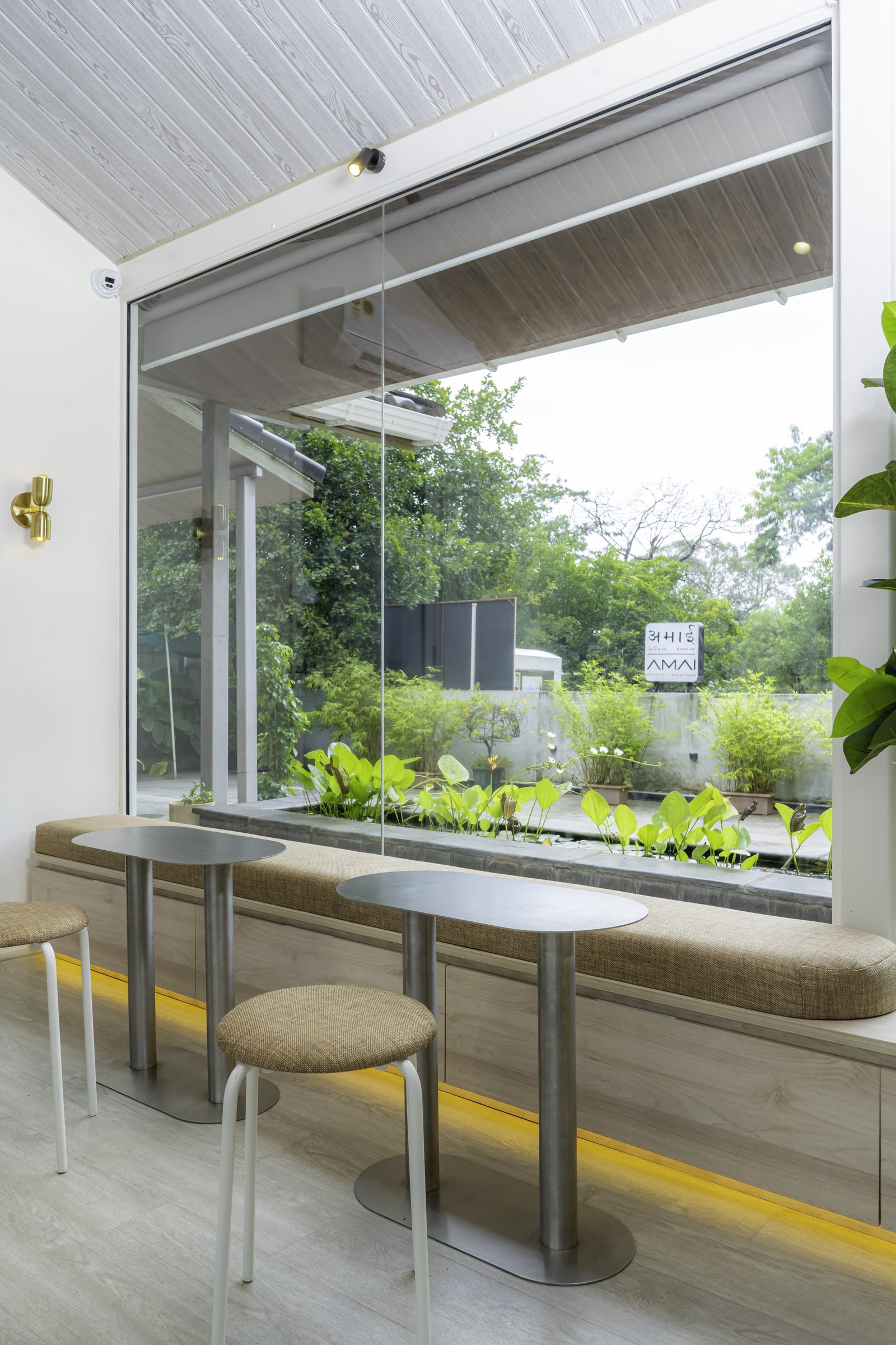 The window seat, where a built-in bench runs the length of the glazing beside the courtyard lily pond