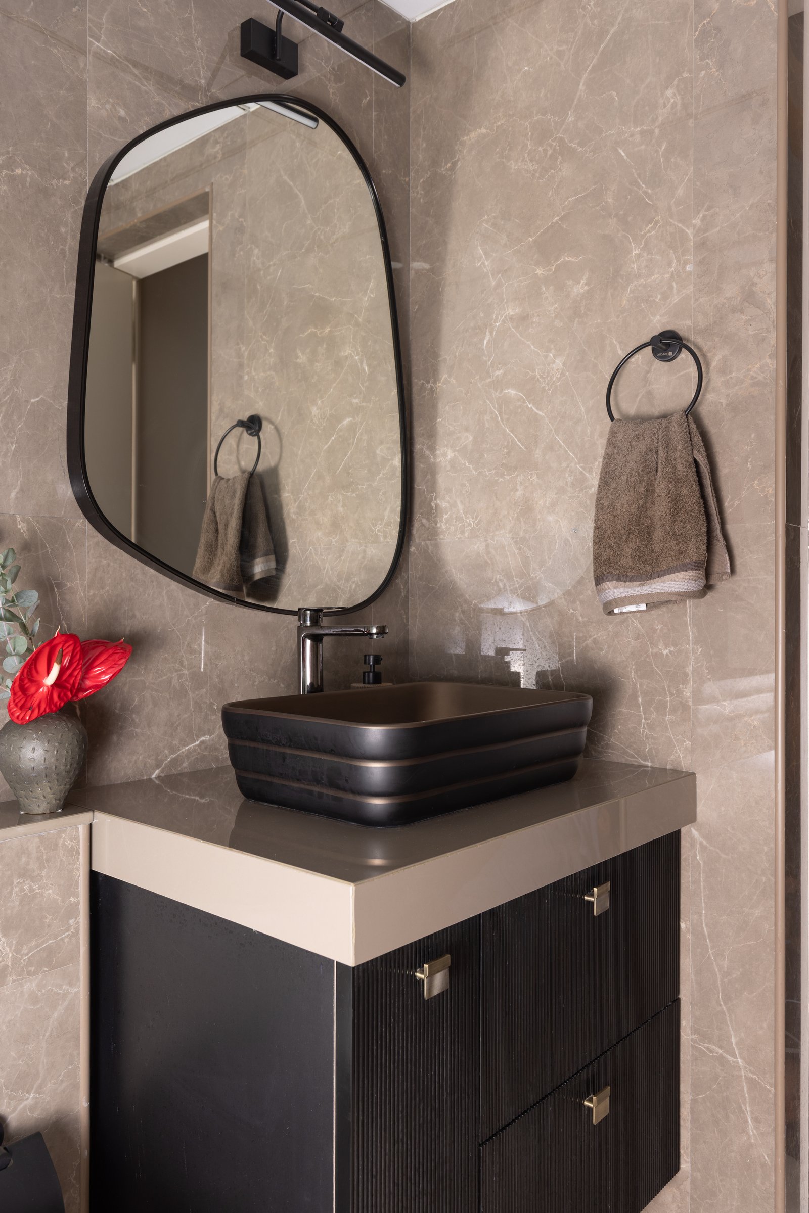 The common bathroom closes the sequence with a return to the home’s darker language