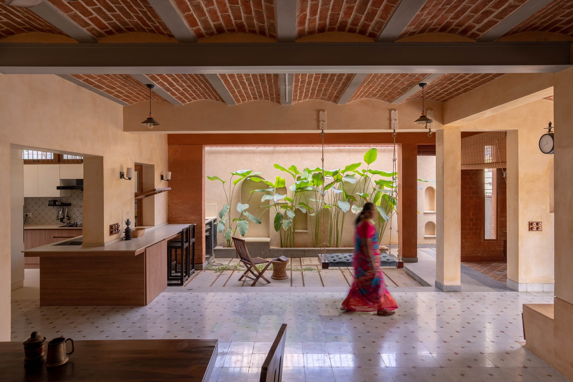 An internal courtyard planted with tropical foliage brings weather and light into the plan