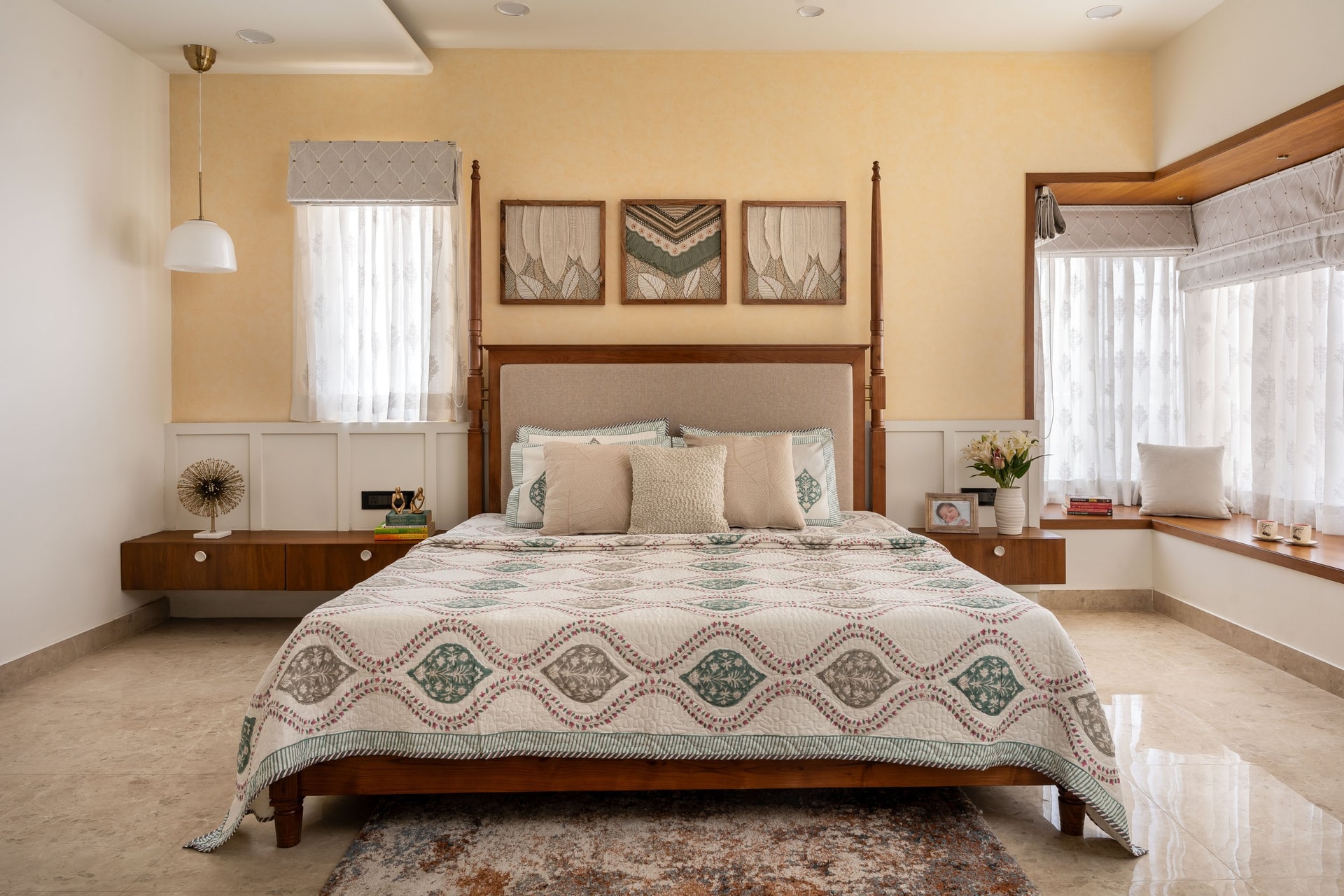 The primary suite, where a four-poster bed sits against ochre plaster and raised-panel wainscoting
