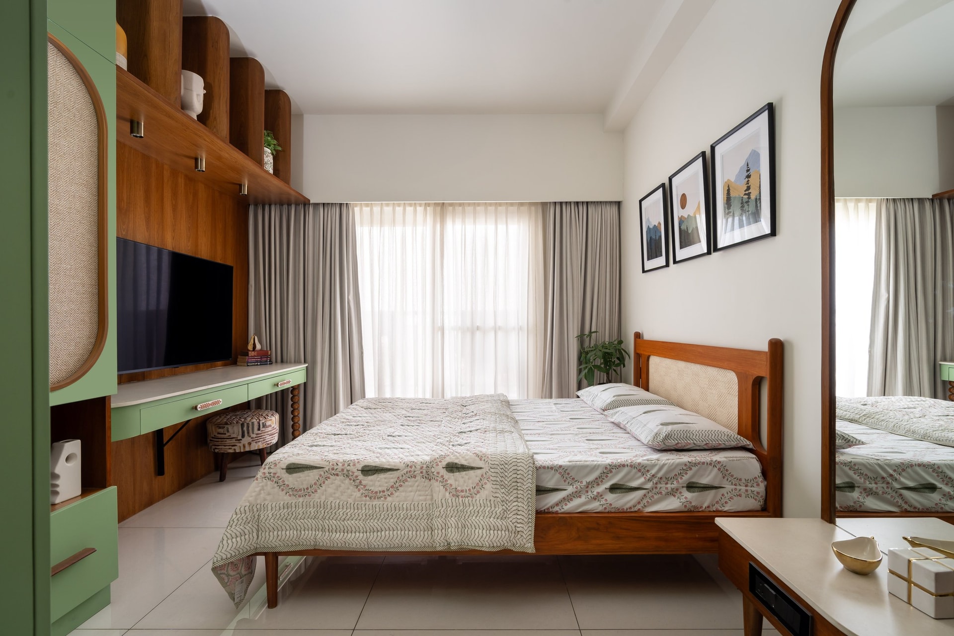 The sons' room, where a cane-inset teak bed sits beneath a trio of muted mountain-scape prints