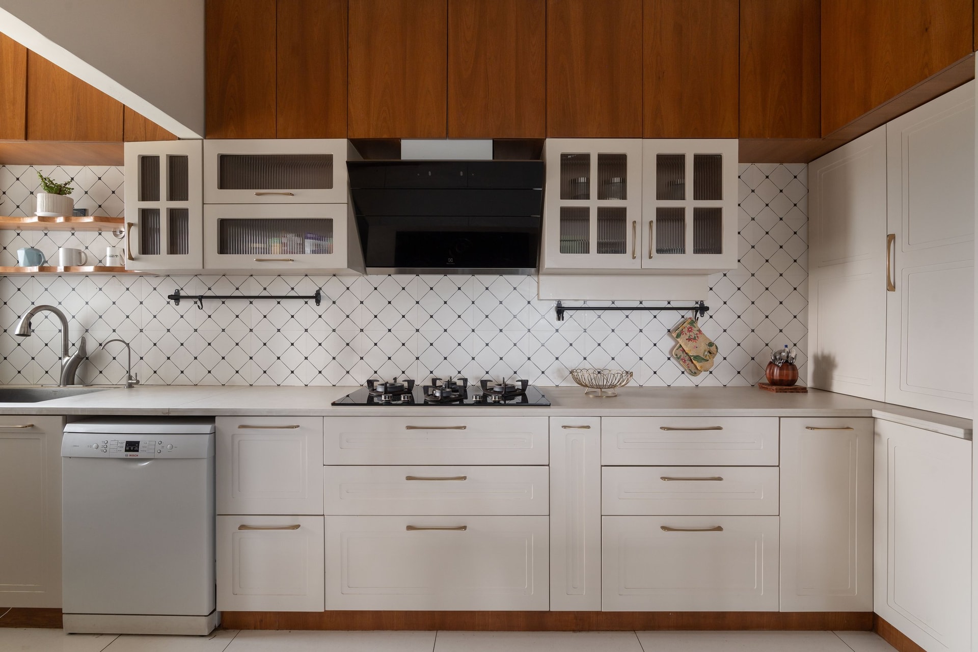 The kitchen, where a diamond-patterned backsplash meets ivory raised-panel cabinets and warm wood uppers