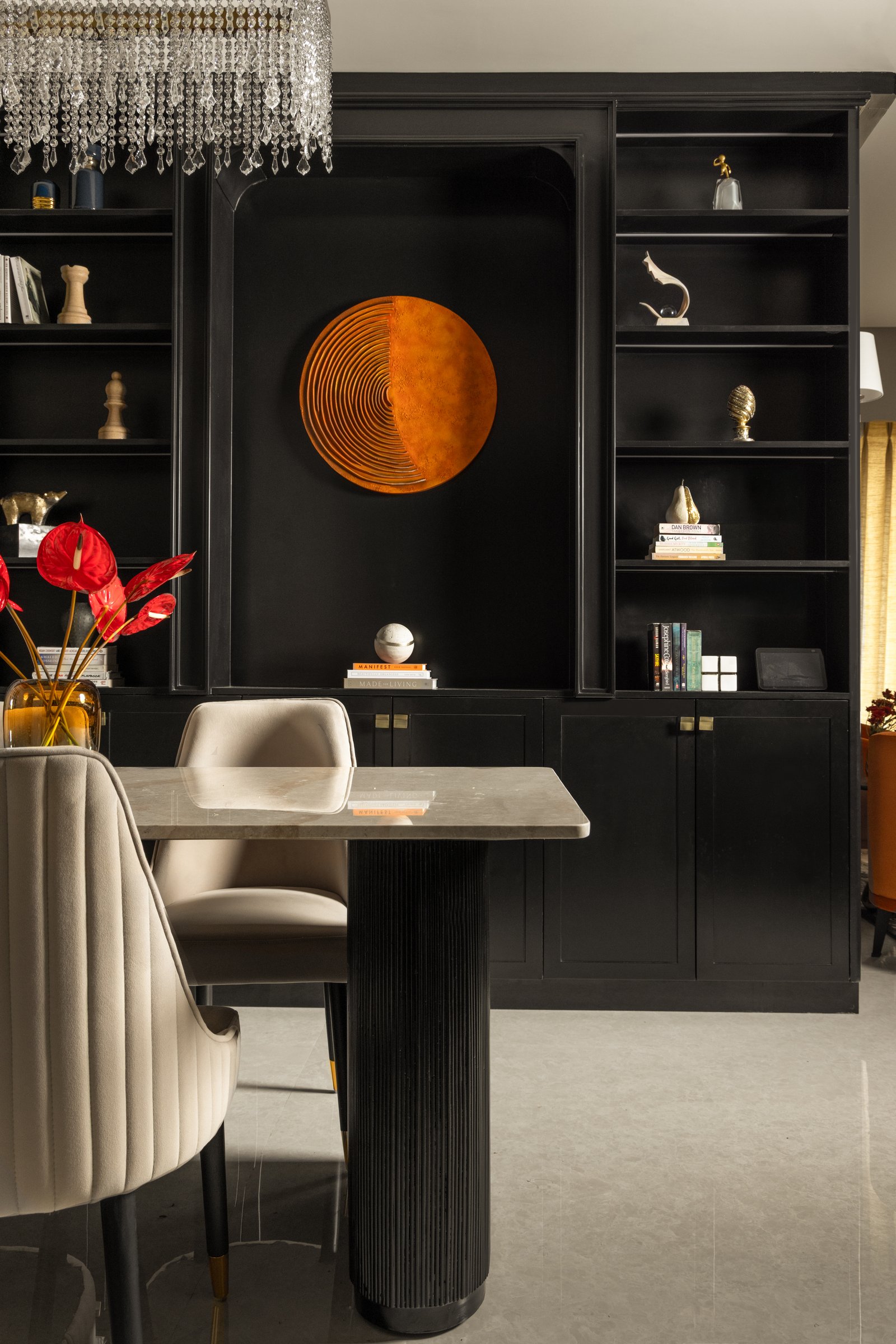 The dining wall, treated as full-height joinery framing a circular burnt-orange artwork