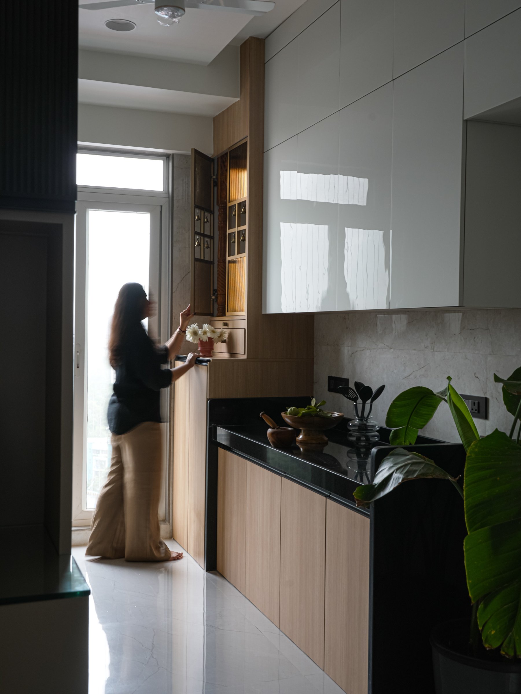 An integrated prayer niche with carved shutters folds spiritual ritual into the everyday plan