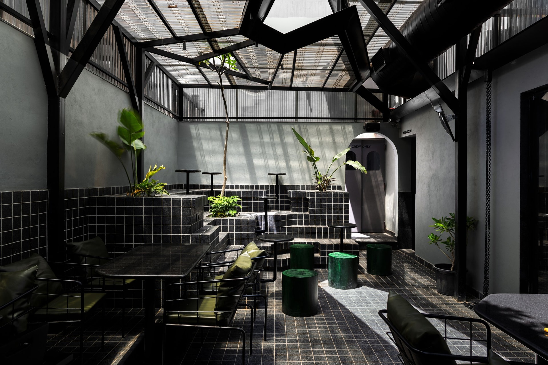 The stepped tile terracing, rising toward the washroom entry marked CREW ONLY