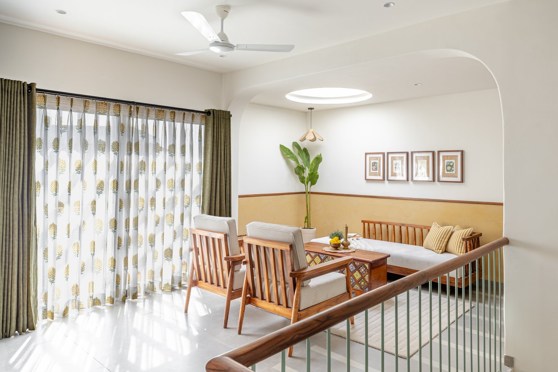 The upper family lounge, where block-printed marigold sheers and a circular skylight shape the room