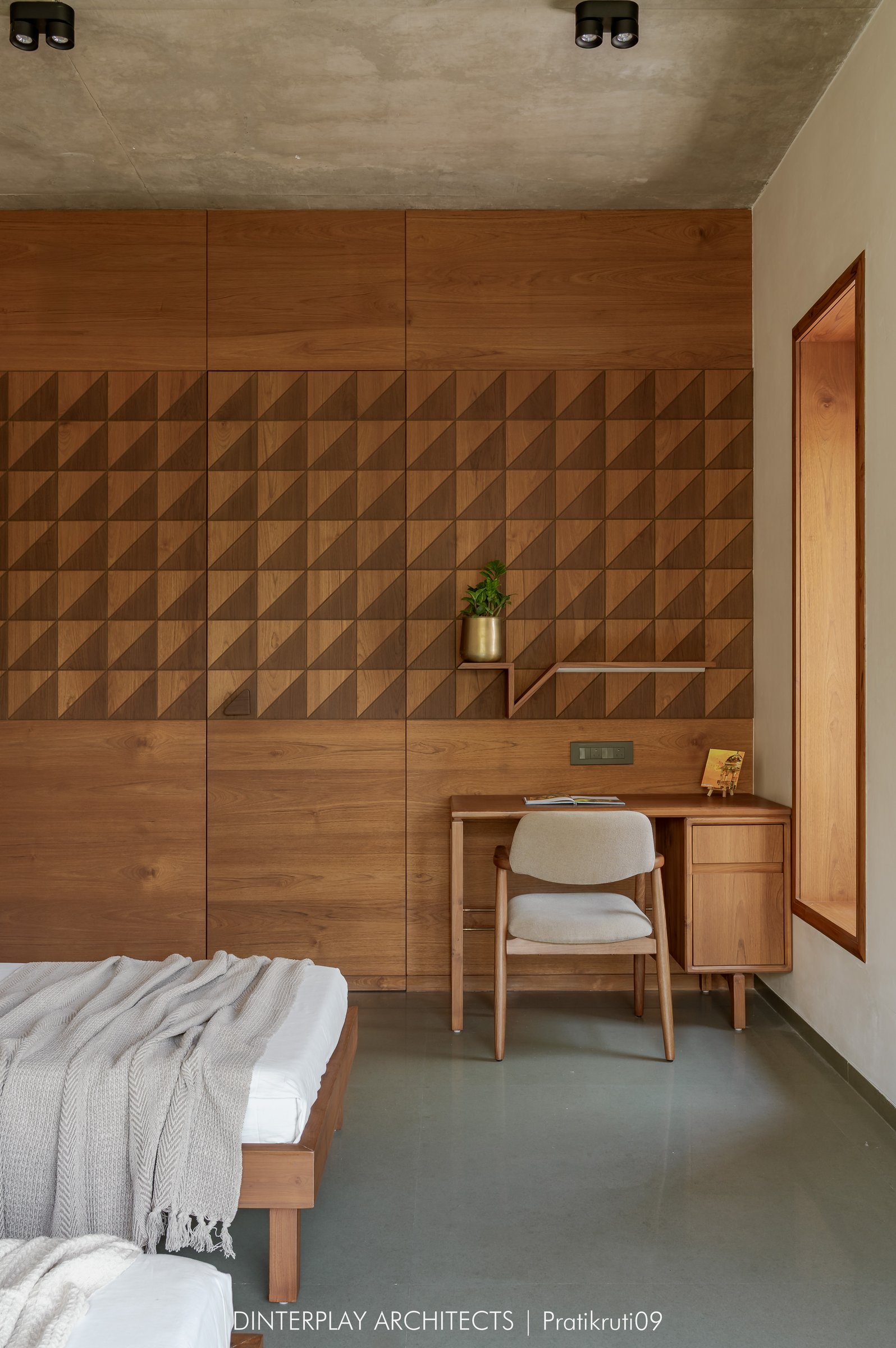 The opposite wall of the children's bedroom, its wardrobe worked in a repeating triangular relief