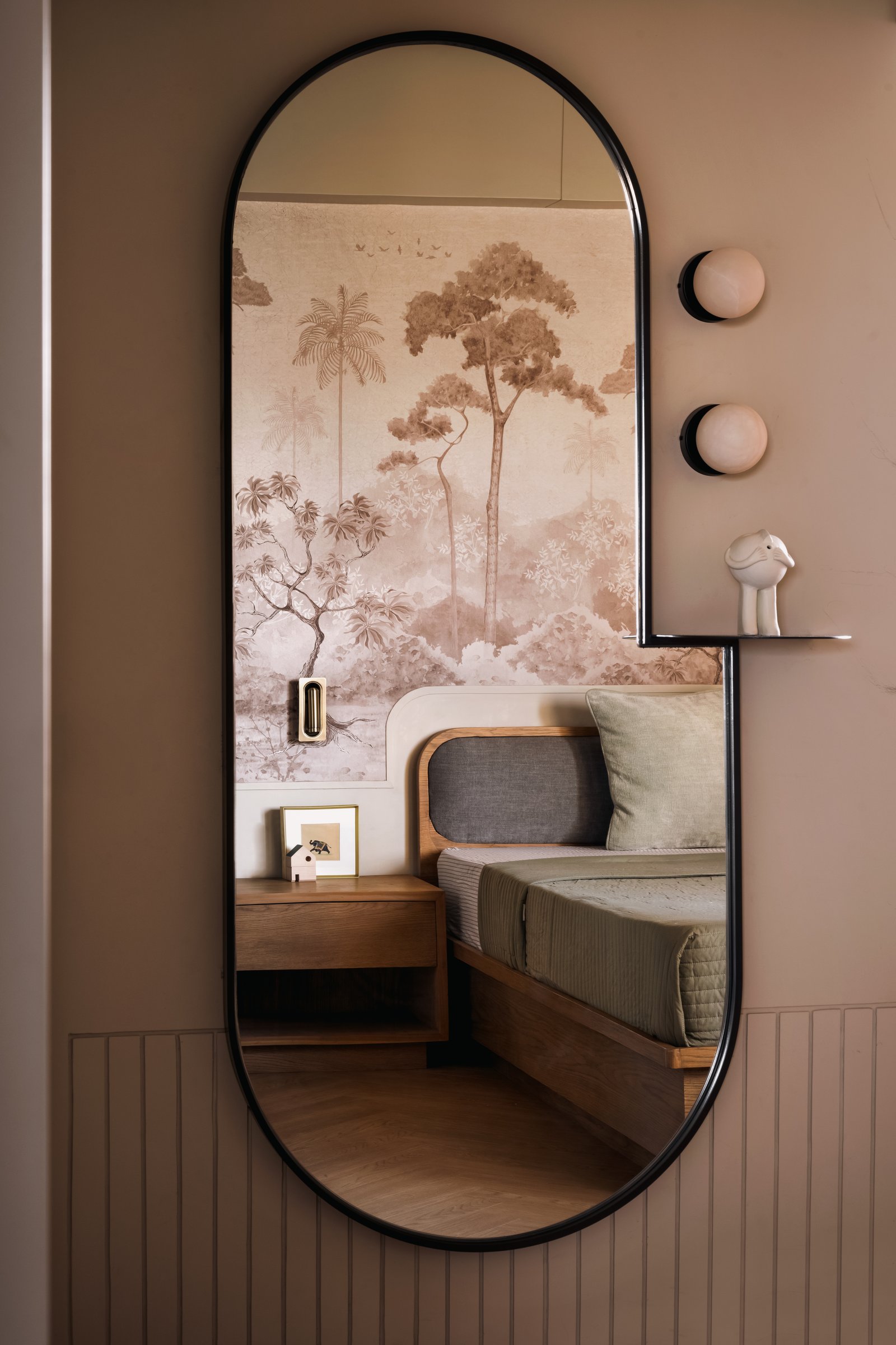 The second bedroom, its headboard wall carrying a botanical mural in muted sepia tones