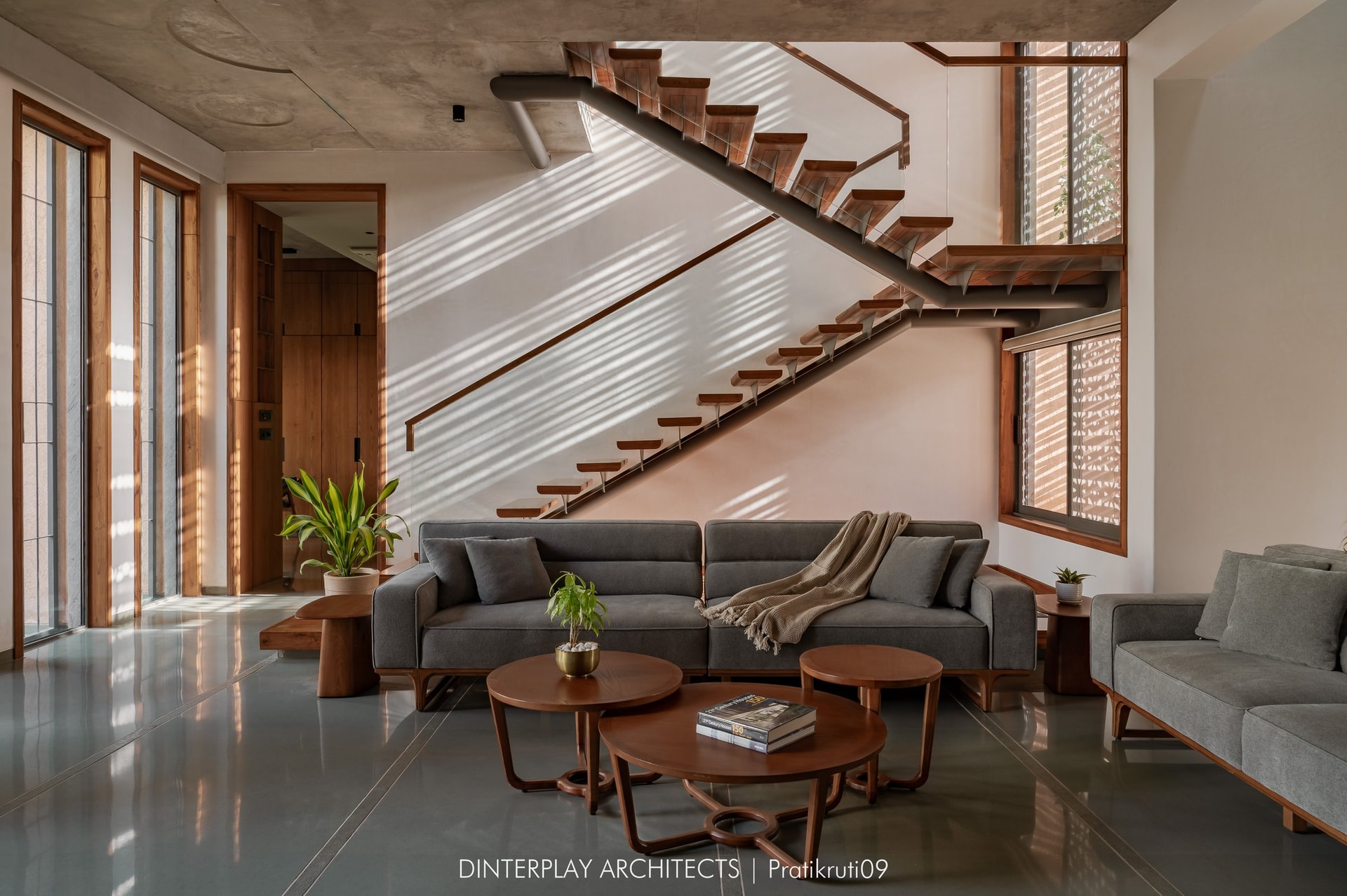 The living room, organised around the sculptural staircase inspired by the human vertebral column