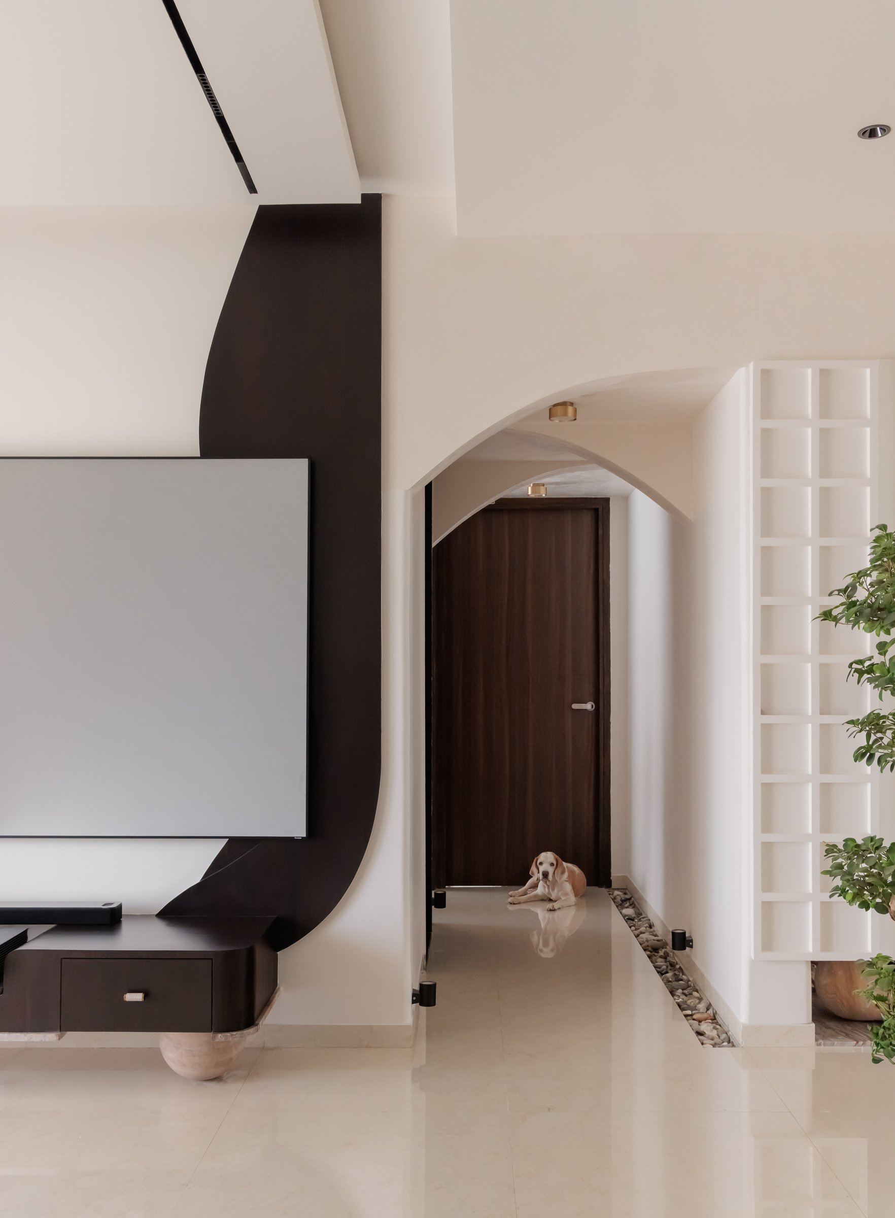 A pebble-filled recess and fluted column give the passage the quality of an internal courtyard