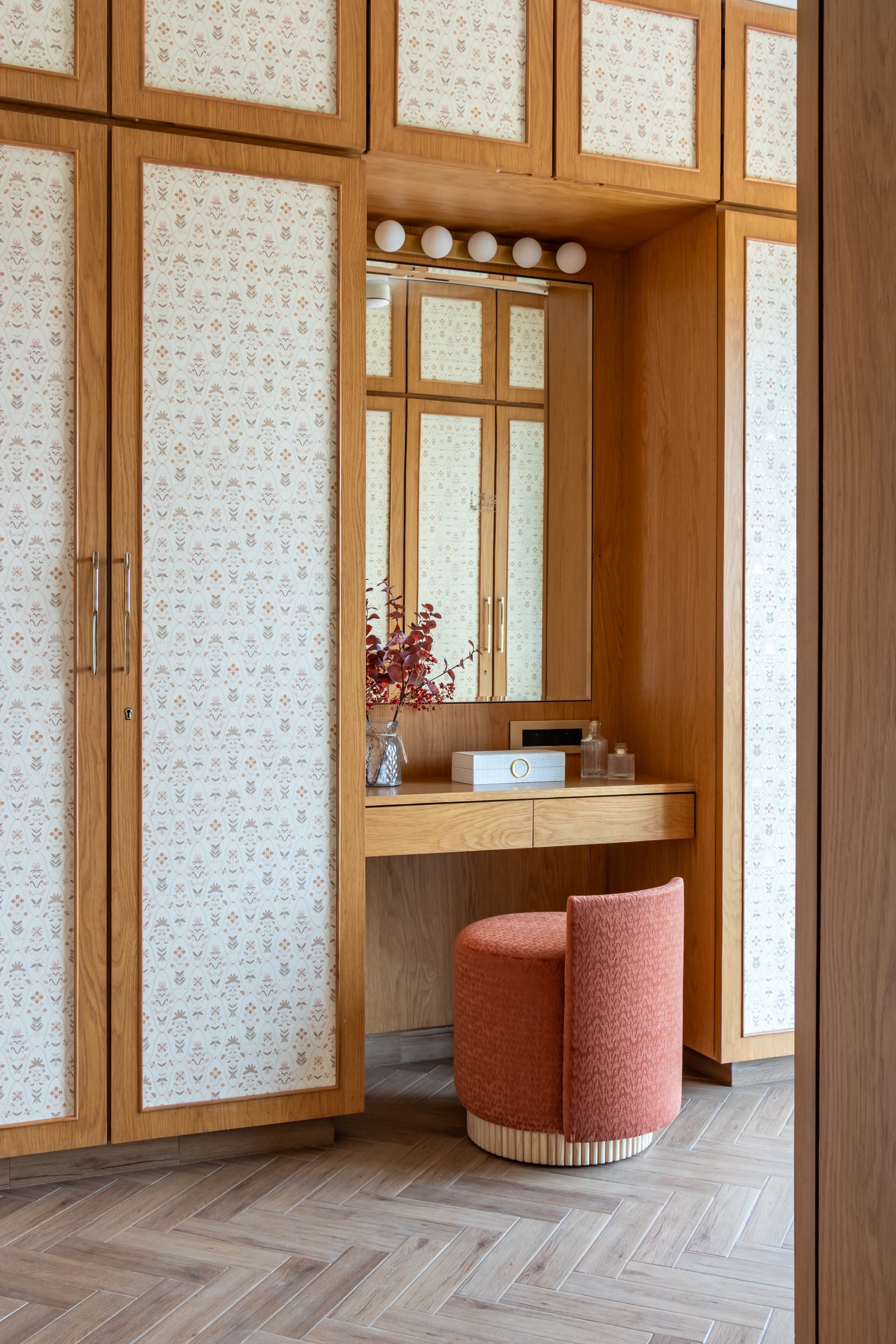 The dressing nook set within the wardrobe joinery, holding grooming within the same material language as storage