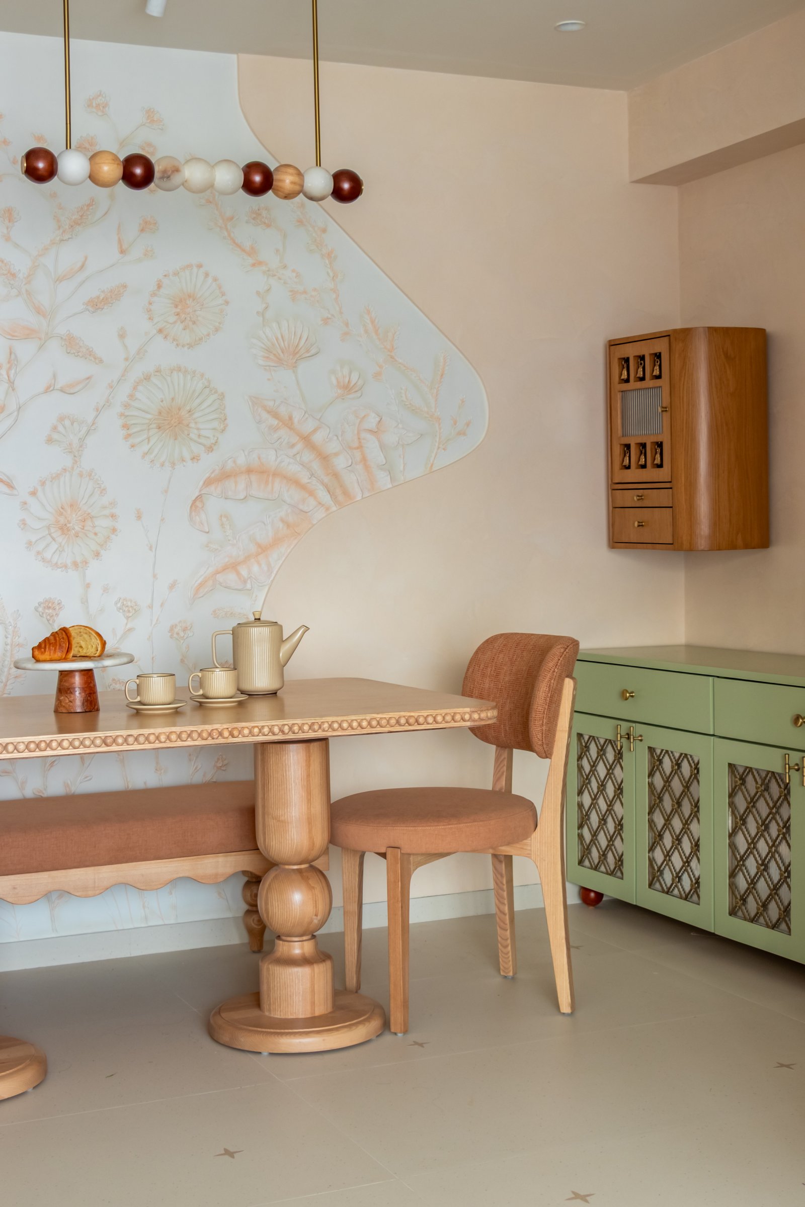 The dining table in turned pine, its bobbin pedestals and beaded edge referencing traditional joinery
