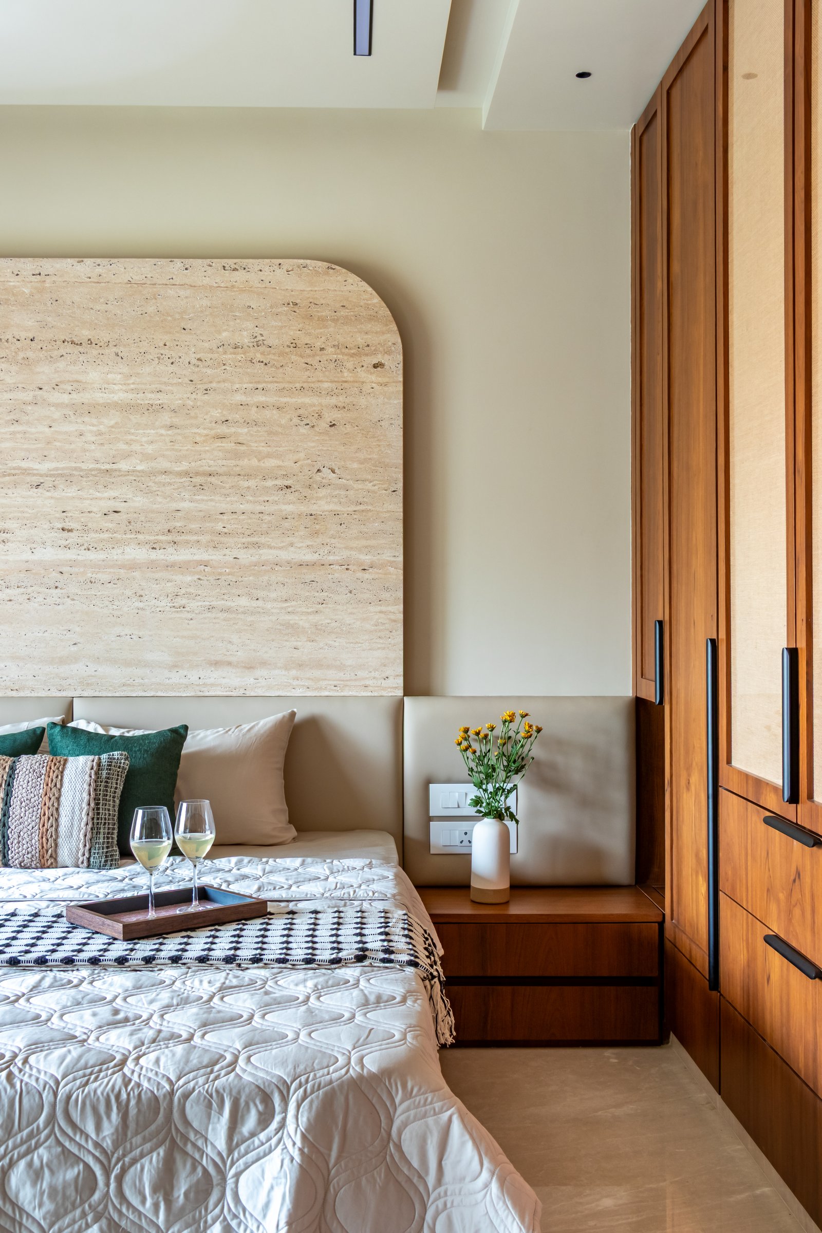 The joinery-clad side of the principal bedroom, where the wardrobe wall reads as a single continuous composition