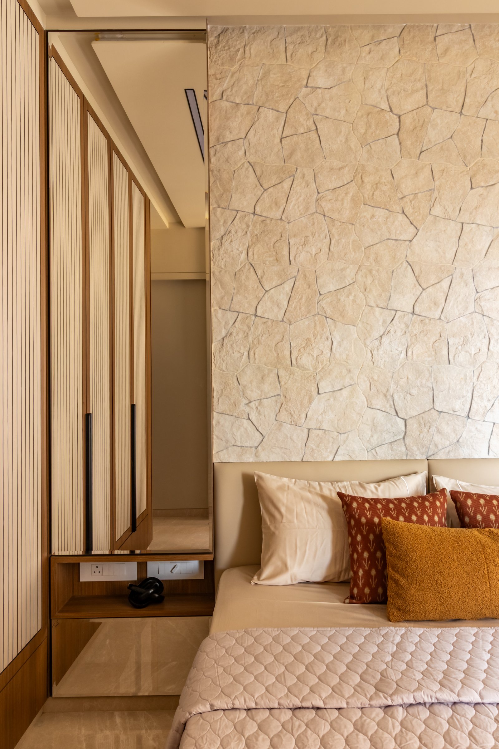 A closer view of the crazy-paved surface and the slatted-panel wardrobe adjacent