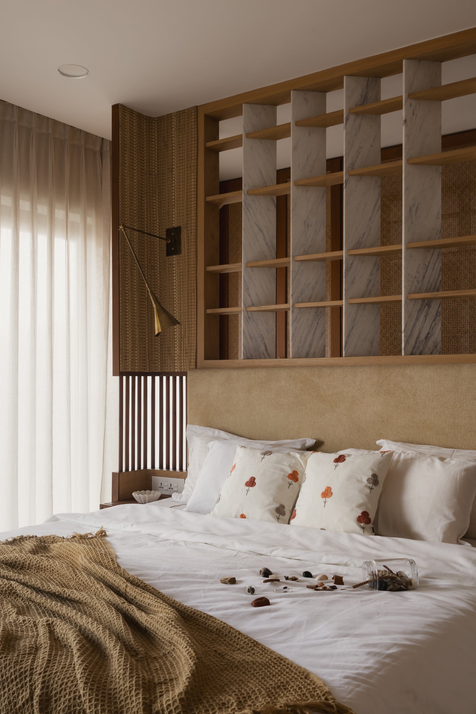 A closer view of the gridded shelf, revealing its layered construction of Banswara marble, oak and rattan