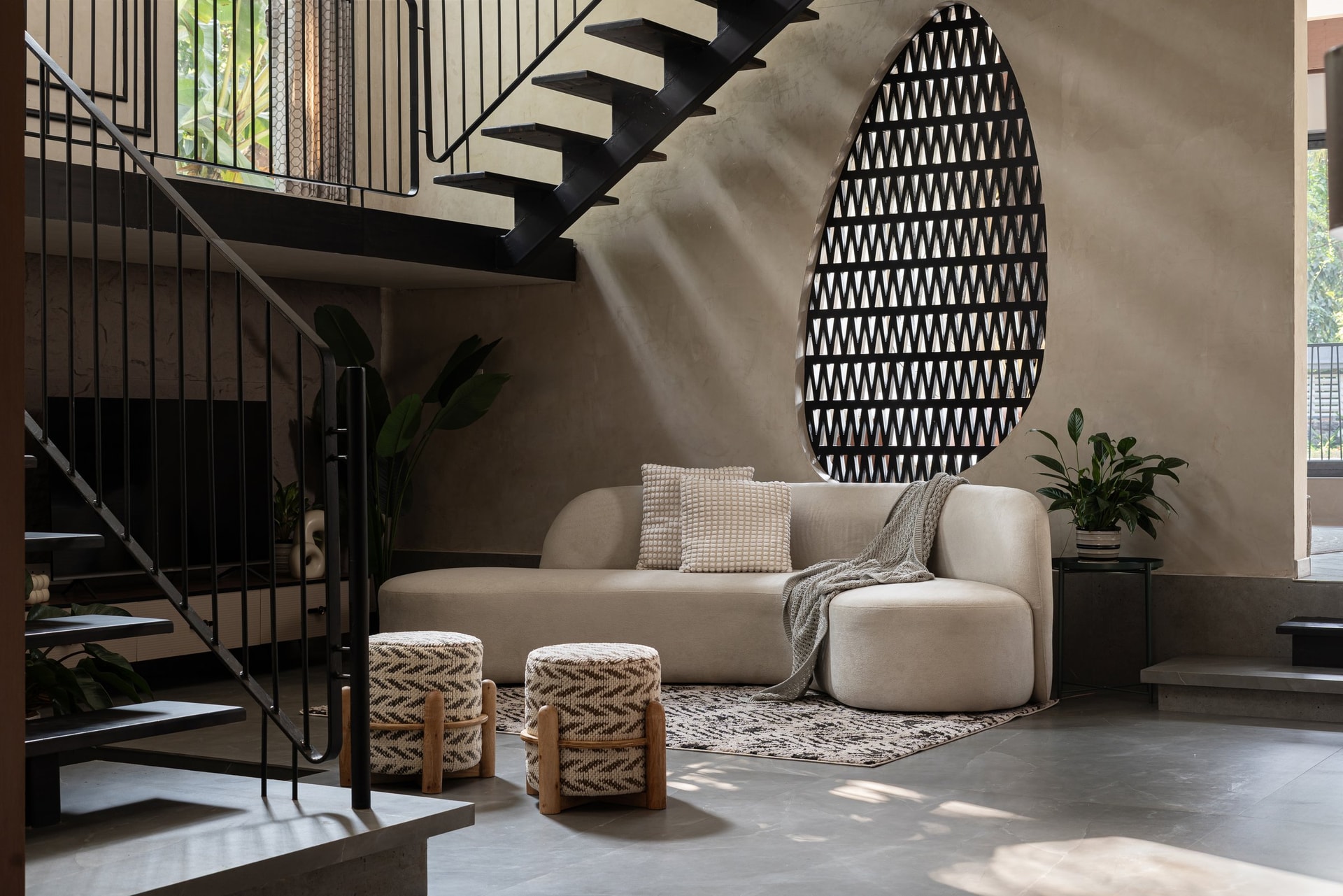 The family living area, organised around the open-tread staircase and an ovoid lattice screen