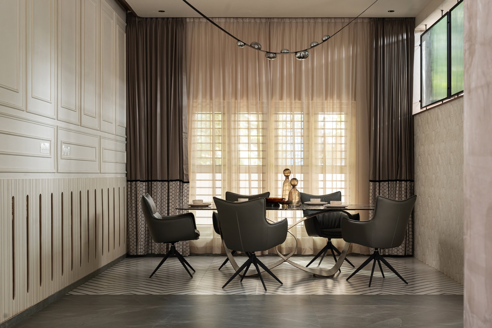 The dining area, held between a grooved wainscot and a textured relief wall