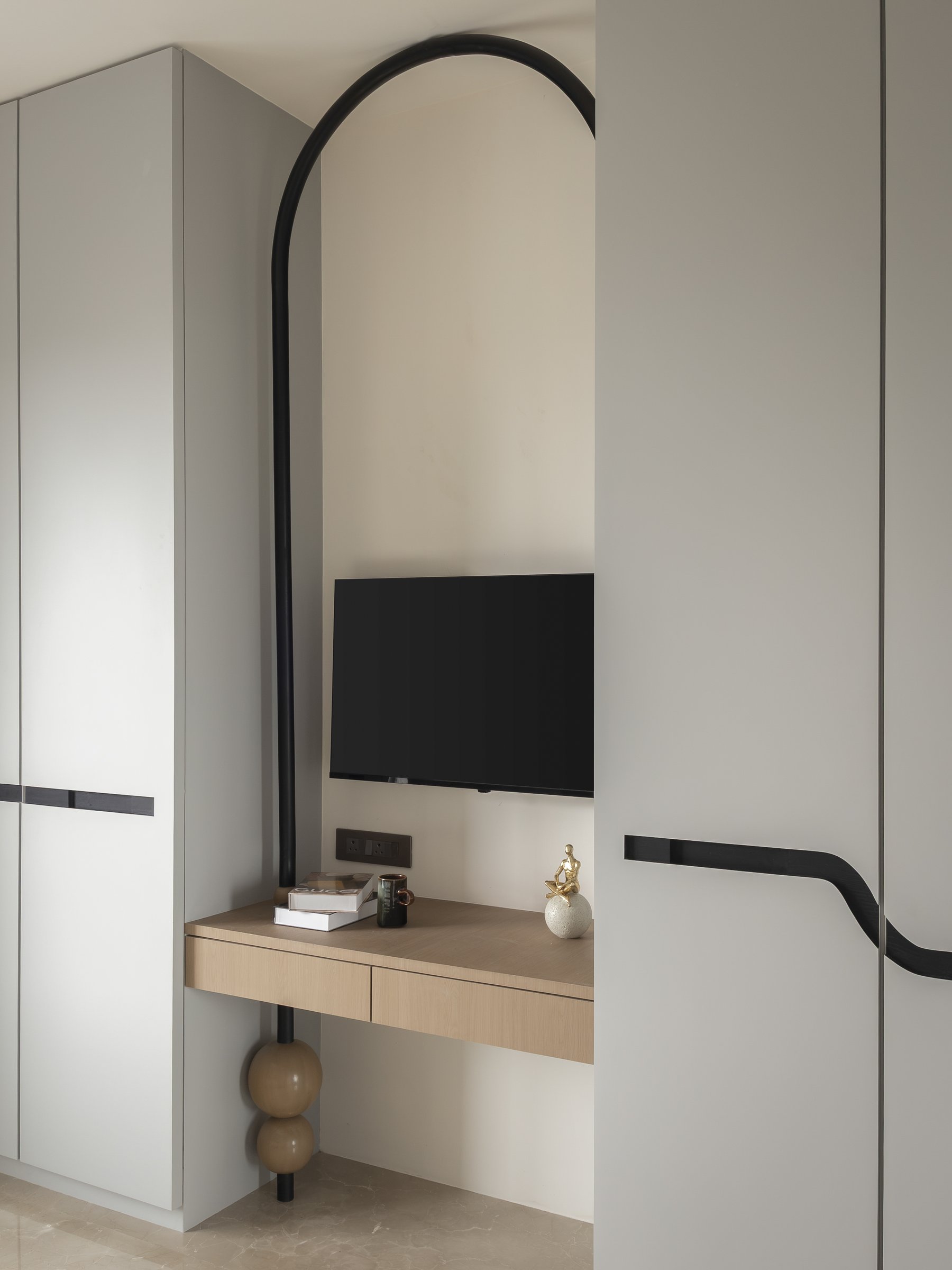 The customised black PU arch defining the study and entertainment zone within the bedroom