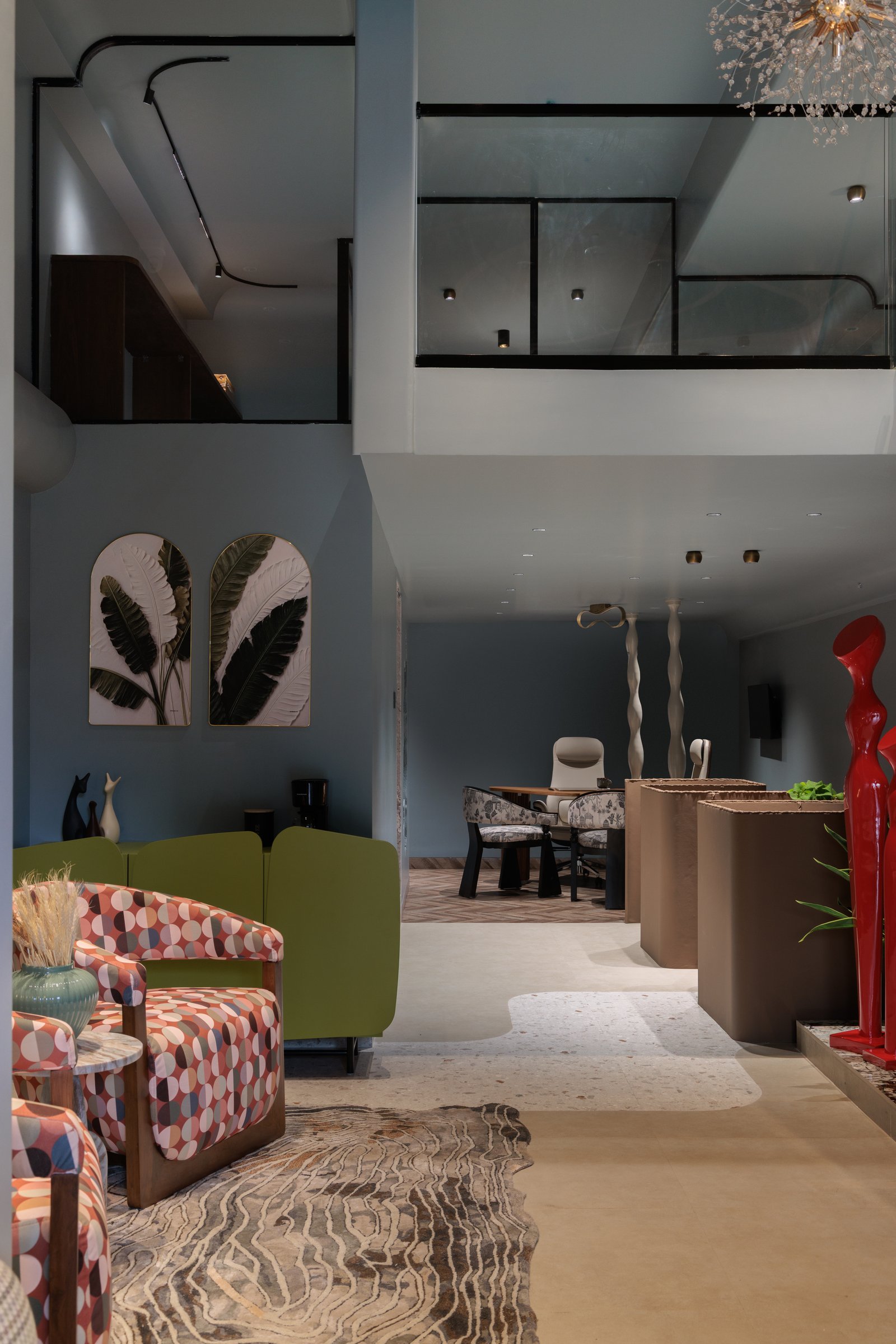 The transition between lounge and meeting zone, marked by a shift from stone flooring to a herringbone wooden floor