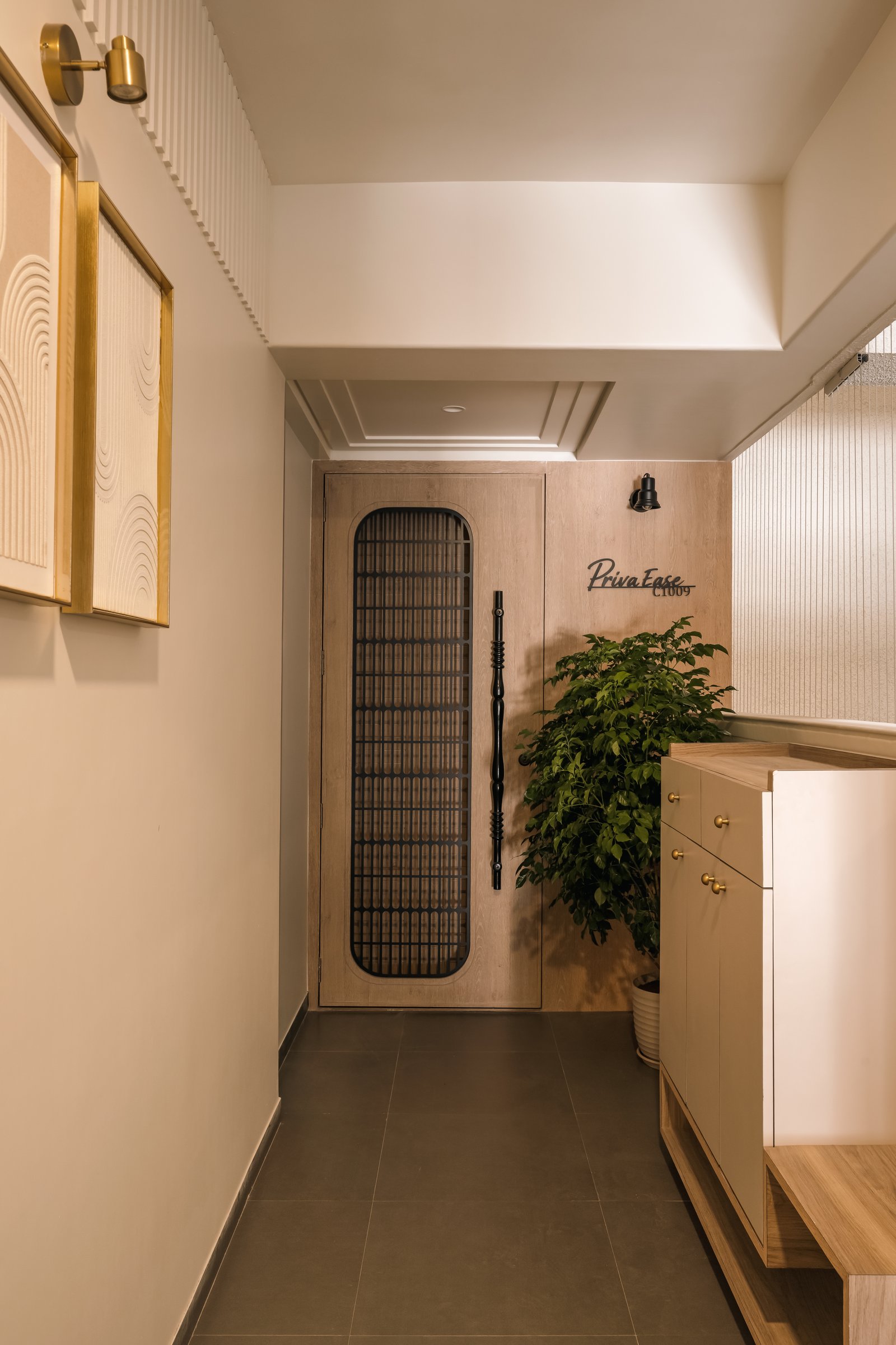 The entry foyer, where a wooden-framed door and a muted beige shoe cabinet set the home's restrained material language