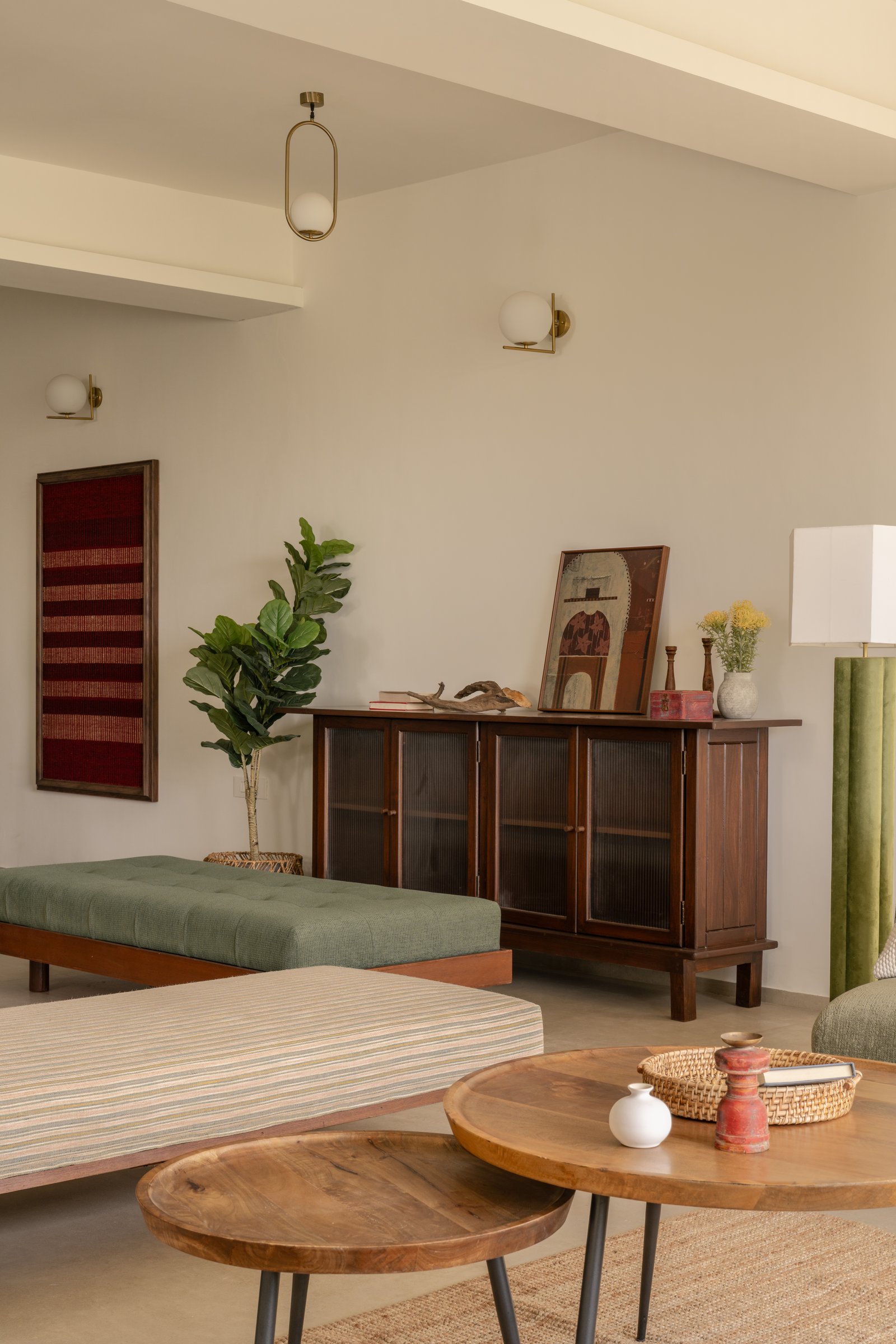 The sideboard wall, where reeded glass and a framed textile piece carry the collected sensibility of the room