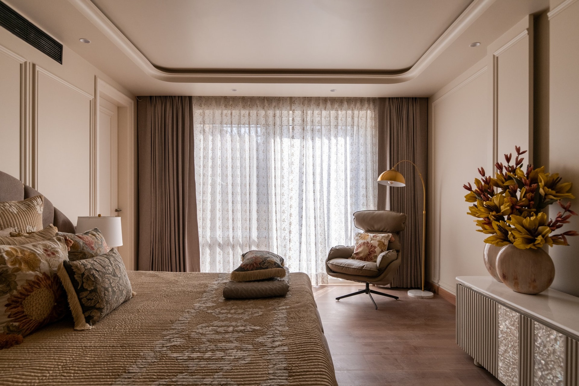 The same suite from the window side, with an upholstered swivel chair beside a fluted-and-inlaid console